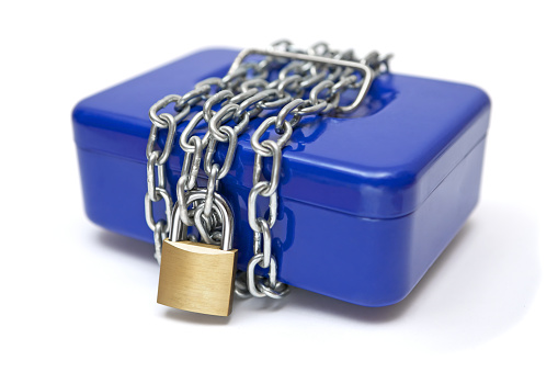 Locking a blue cash box with chain and padlock. Isolated on a white background.