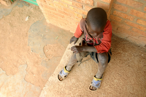 Child carrying water home from he local well in Entebbe, Uganda