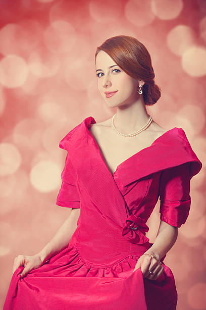 A young Indian woman posing for her nobility portrait. Off-centered composition, desaturated colors, overall red tint and washed-out look is intentional.