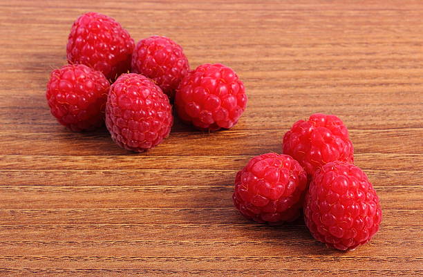 istock Fresh raspberries on wooden surface, healthy food 483201044