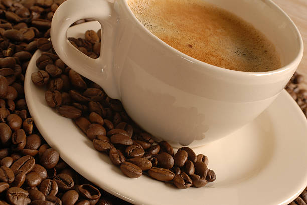 Cup of coffee with roasted beans stock photo