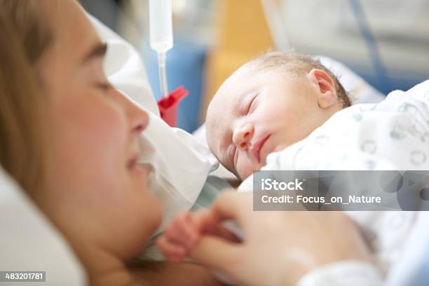 Woman Holding Her 2 Days Old Daughter Stock Photo - Download Image Now - Hospital, Newborn, Baby Girls