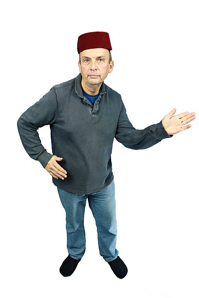 istock Red Fez wearing white male middle aged man hands pointing 483202119