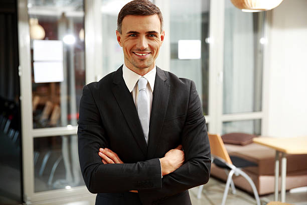 istock businessman standing with arms folded 483202179