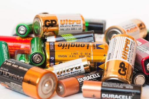 Oslo, Norway - May 5, 2013:Collection of different  colorful battery brands as  Duracell, GP, Kodac, Ucar  Varta, Philips and others on white background.
