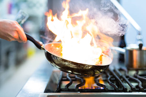 istock Chef in restaurant kitchen at stove with pan 483203743