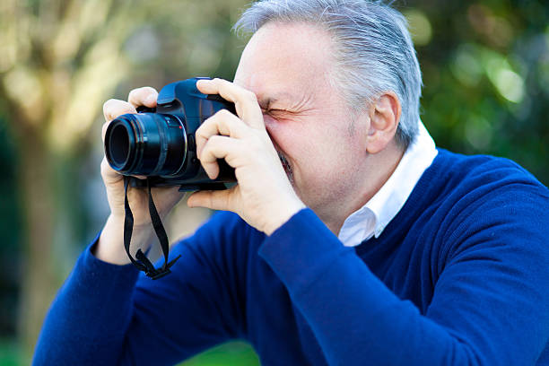 istock Enthusiastic photographer taking a photo outdoor. 483204373