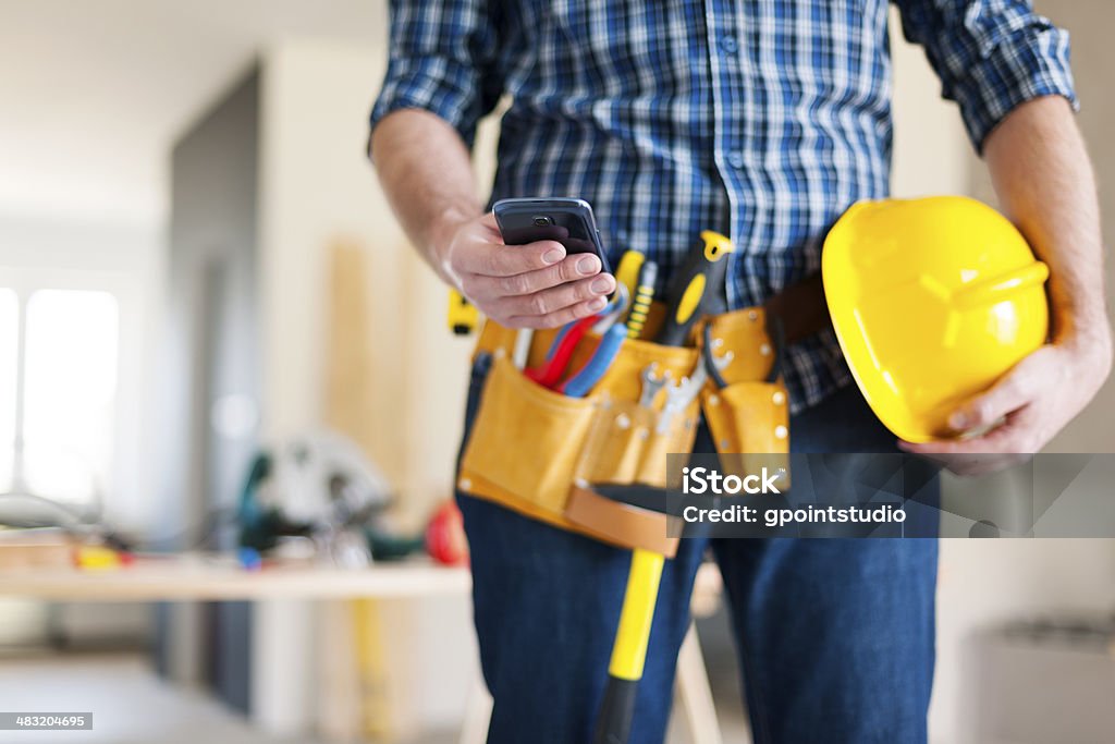 Close up of construction worker with mobile phone Telephone Stock Photo