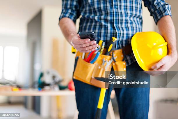 Close Up Of Construction Worker With Mobile Phone Stock Photo - Download Image Now - Telephone, Tool Belt, Construction Worker