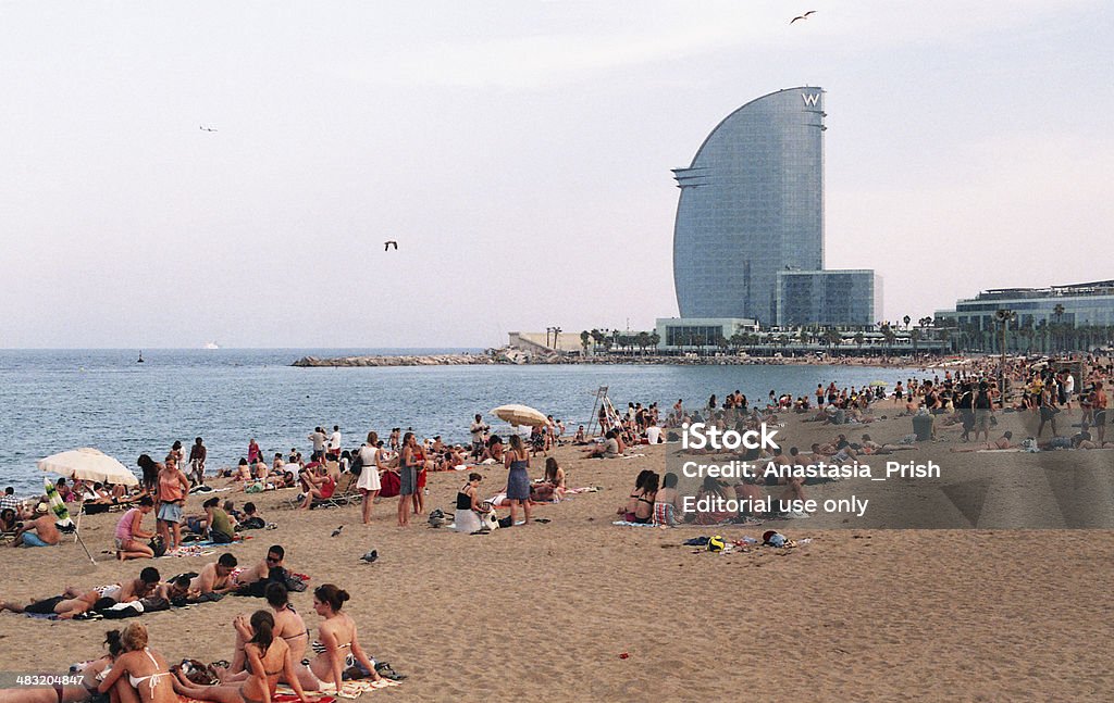 Beach in barcelona Barcelona, Spain - July 16, 2013: people are sunbathing on the beach in front of hotel W Adult Stock Photo