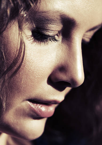 istock Sad beautiful woman with long curly hairs looking down 483205662