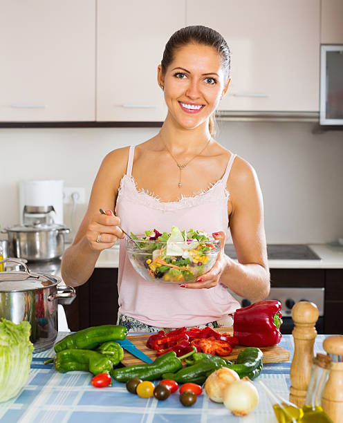 istock Happy girl standing at kitchen table 483207416