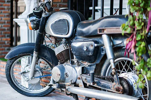 An Old motorcycle in vintage place .