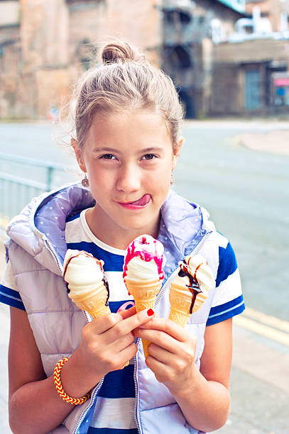istock Happy smiling young cute girl with many ice-cream. Outdoors image. 483215680