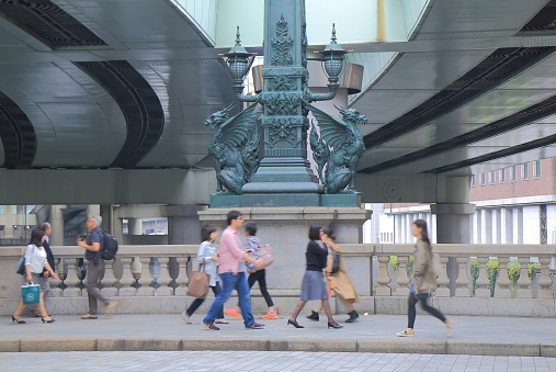 Tokyo Japan - May 9, 2015: People cross historical Nihonbashi bridge which was first constructed in 1603 in Tokyo Japan.
