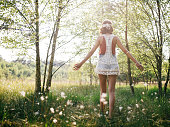 Boho girl walking through summer park feeling free