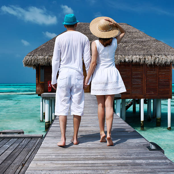 istock Couple on a beach jetty at Maldives 483226909