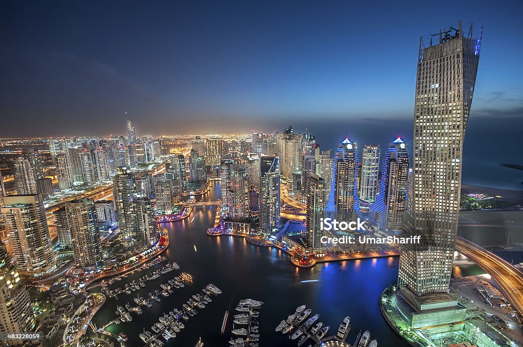 Dubai Marina tallest skyscrapers during Blue hour Shot of Dubai Marina and Jumeirah Lakes Towers. City of Tall buildings and towers. Taken at Blue Hour. Apartment Stock Photo