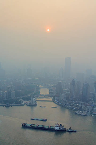 Shanghai, China - June 16, 2013: View of heavily polluted skyline over Huangpu river. Heavy air pollution has become common in many cities in China.