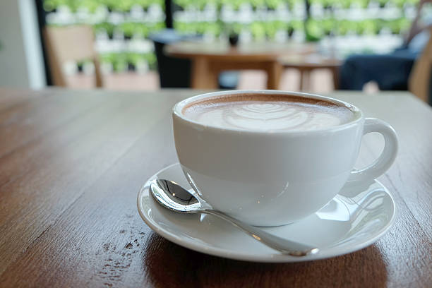 istock White cup of beautiful hot cocoa on wooden table 483230418