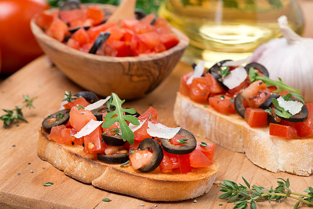 istock ciabatta with tomatoes, olives, parmesan on a wooden board 483230717