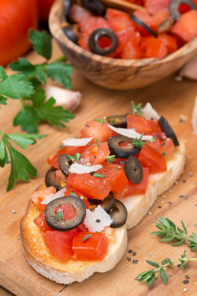 istock ciabatta with tomatoes, olives, parmesan on a wooden board 483230799