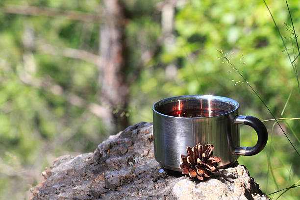 istock Metal mug with red tea stands on a rock 483231548