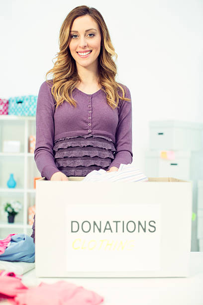 istock Woman packing clothes for donation. 483231683