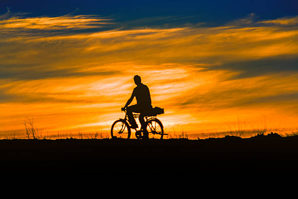 istock Sunset on The river with Happy Man Bicycle 483233601