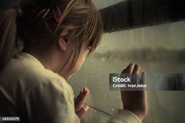 Lonely Child Looking Through Window Stock Photo - Download Image Now - Child, Child Abuse, Sadness