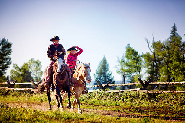 istock Cowboy and cowgirl riding 483234225