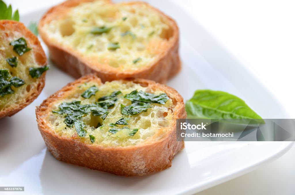 garlic bread with basil on white background some slice of garlic bread with basil on white background 2015 Stock Photo