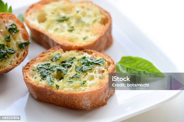 Garlic Bread With Basil On White Background Stock Photo - Download Image Now - 2015, Basil, Bread