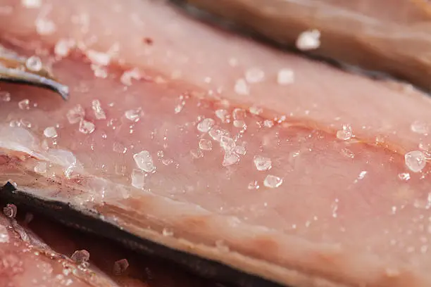 Photo of Large christals of sea salt at mackerell fillet macro