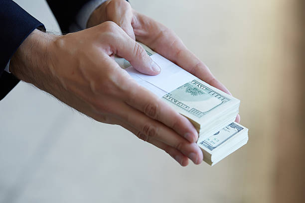 istock closeup money in male hands 483249602