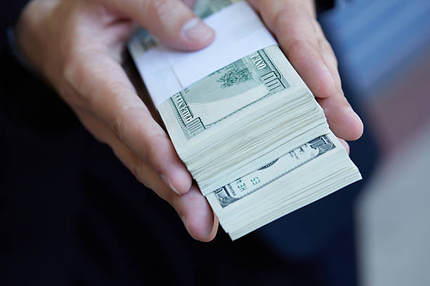 istock closeup money in male hands 483251872