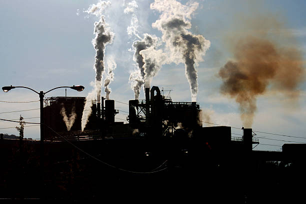 Smoke rises in the shadows in this factory