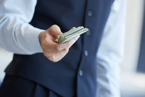 istock closeup money in male hands 483255726