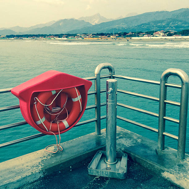 Forte dei Marmi (Tuscany, Italy): a long belvedere pier, specifically built for pedestrians, allows a panoramic view of part of the Tuscan and Ligurian coast of Italy. A drinking-water stainless-steel fountain and a life buoy are visible in the foreground. Shot with iPhone 5, toned
