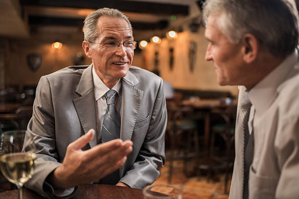 istock Smiling businessmen in a bar. 483260185