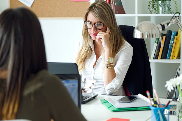 istock Two business woman working in her office. 483261912