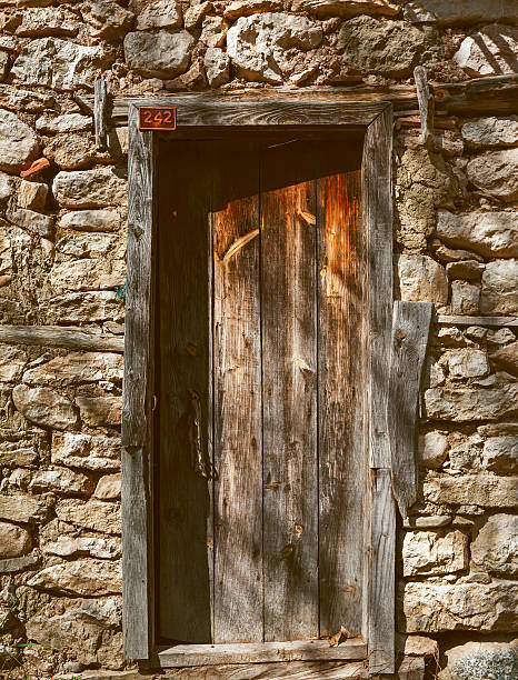 istock wooden door and  stone wall 483262137