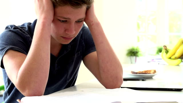 Slow Motion Sequence Of Depressed Boy Studying At Home