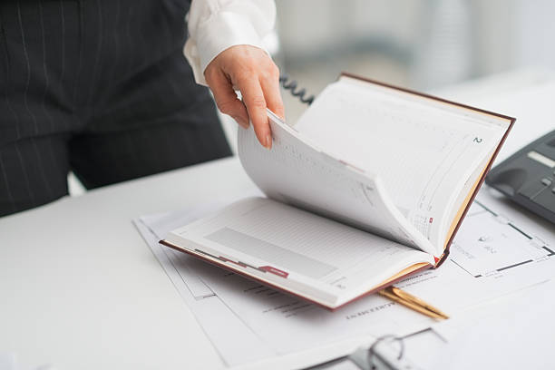 istock closeup on modern business woman checking notepad 483263041