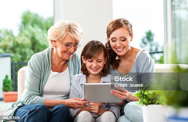 Three Generation Family With Digital Tablet Stock Photo - Download Image Now - Digital Tablet, Grandmother, 25-29 Years