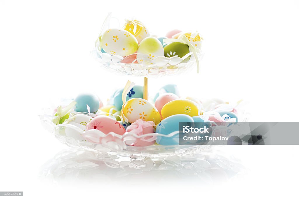 Easter eggs Decorated and colored easter eggs in glass bowl isolated on white Animal Egg Stock Photo