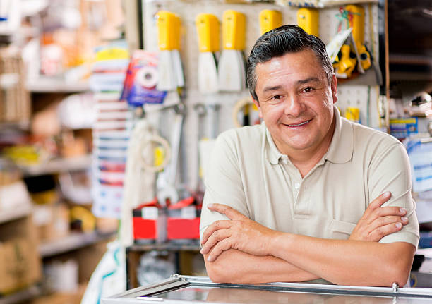 Man at a hardware store Friendly man working at a hardware store looking happy hardware store photos stock pictures, royalty-free photos & images