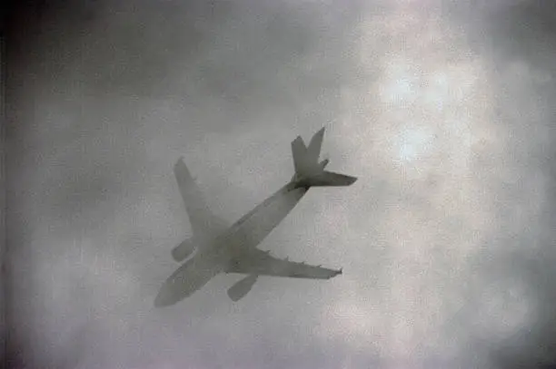 Photo of Airplane passing in low clouds