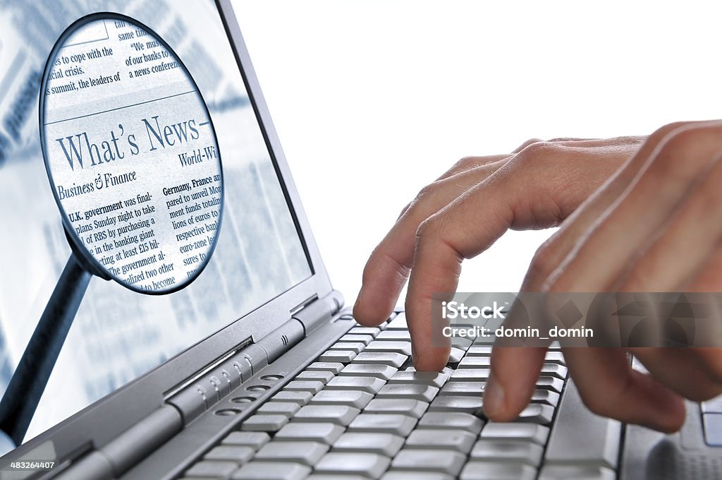 OnLine News, man's hands laptop keyboard, magnifying glass on screen Man's hands are entering some words on the laptop keyboard for the Internet news. Both images you may buy separately here: laptop with hands #7292297 and magnifying glass #7756620 Article Stock Photo