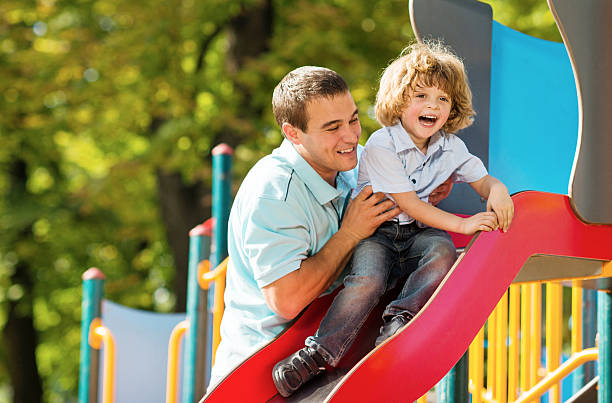 istock Playful father and son at the playground. 483264581